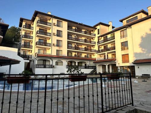 a large building with a fence in front of it at Spacious Fully Furnished Studio in Kavarna Apart Hotel in Kavarna
