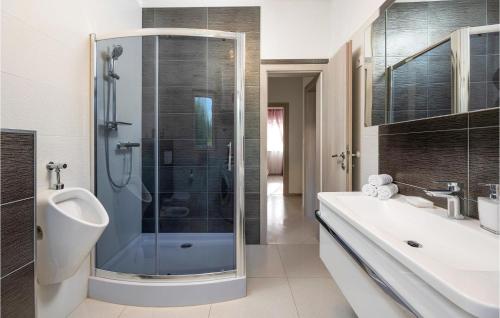 a bathroom with a shower and a sink and a toilet at Nice Home In Kastel Novi With Jacuzzi in Kastel Novi