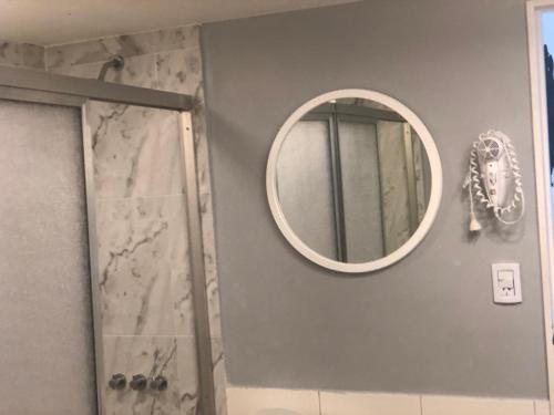 a bathroom with a mirror and a shower at Las Naciones 1710 in Buenos Aires