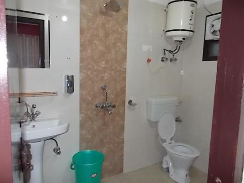 a bathroom with a toilet and a sink at Bhawani Kutir Villa Nainital in Nainital