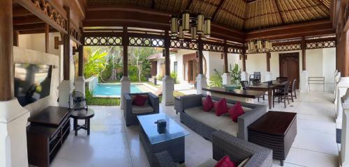 a lobby of a resort with couches and tables at Jimbaran BeachStroll Villa (2BR) in Jimbaran
