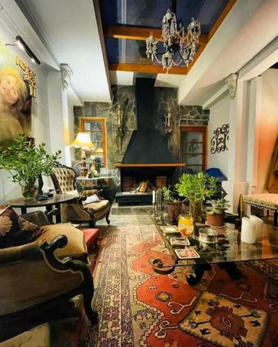 a living room with a fireplace and a couch and a table at A Hotel Boutique Pelluhue in Pelluhue