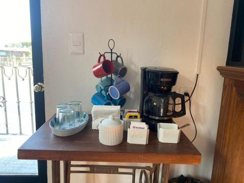 a wooden table with a coffee maker on it at Hotel La Lejona in San Miguel de Allende