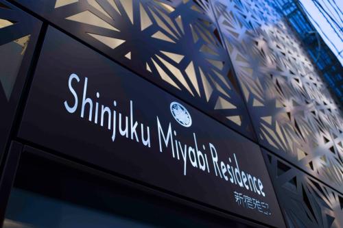 a sign on the side of a building at Shinjuku Miyabi Residence - Vacation STAY 94520 in Tokyo