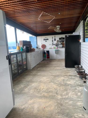 a large kitchen with a counter in a room at Giăng's House Farmstay & Glamping in Bao Loc