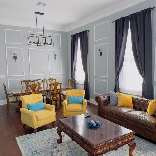 a living room with a couch and chairs and a table at Walk to French Quarter Canal Suite Guesthouse in New Orleans