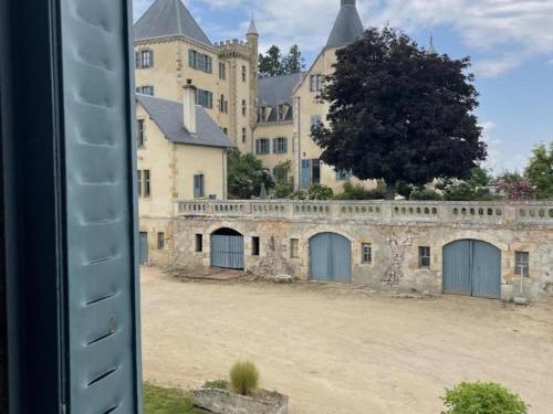 a view of a large castle from a window at Demeure de caractère avec piscine et parking, animaux admis, wifi - FR-1-489-457 in Vernusse