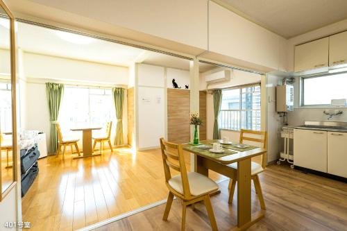 eine Küche und ein Esszimmer mit einem Tisch und Stühlen in der Unterkunft NanEi Building in Kagoshima