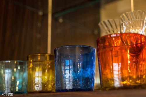 four different colored glasses sitting on a table at NanEi Building in Kagoshima