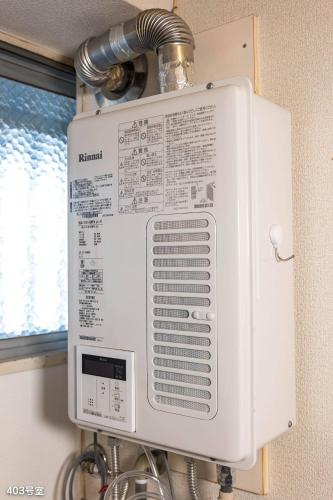 a large white air conditioner sitting on a wall at NanEi Building in Kagoshima