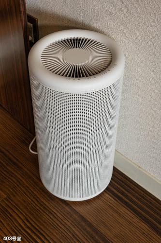 a white heater sitting on the floor next to a wall at NanEi Building in Kagoshima