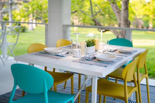 a white table with yellow chairs around it at 1850 Catskills Farmhouse on 8 acres in E. Durham in East Durham