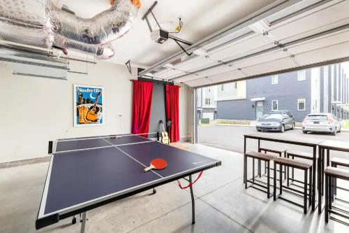 a ping pong table in a room with a ping pong ball at Rooftop Skyline View - Karaoke Stage - 4 Bedroom in Nashville