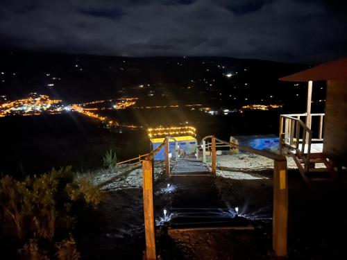 a stairway leading up to a building at night at Glamping Cielo Roto in Sutamarchán