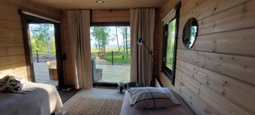 a bedroom with a bed and a large sliding glass door at Villa Terwaluoto in Hailuoto