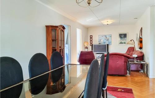 a living room with a glass table and chairs at Lovely Home In Göteborg With Kitchen in Gothenburg