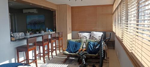 a balcony with a bar with chairs and a table at Shangri-la Doonside in Kingsburgh