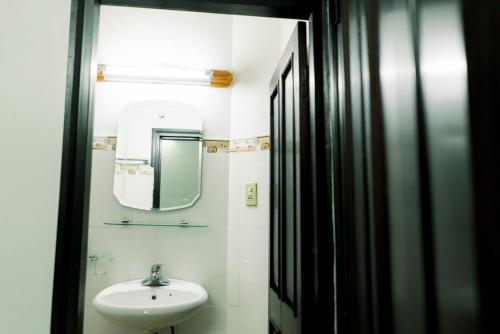 a bathroom with a sink and a mirror at Be Them homestay in Hue