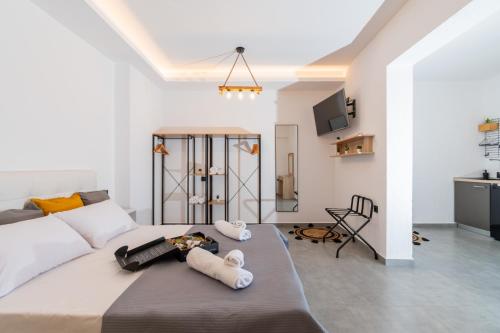 a bedroom with a bed with towels on it at Nuovo Suite in Neos Marmaras