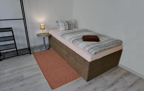 a bed with a brown bag sitting on top of it at Wohnung für 1 bis 3 Personen in Solingen