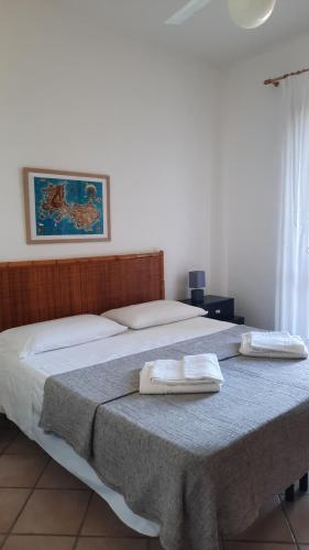 ein Schlafzimmer mit einem Bett mit zwei Handtüchern darauf in der Unterkunft Le Ciaramire in Favignana