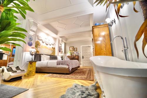 a bathroom with a bed and a tub in a room at Yuu Hotel Ubon Ratchathani in Ubon Ratchathani