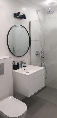 a bathroom with a white sink and a mirror at Aksioma Kotor in Kotor