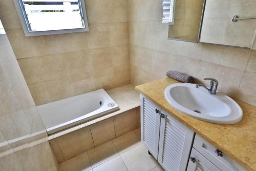 a bathroom with a sink and a bath tub at Rothschild Allenby Penthouse 2BD in Tel Aviv