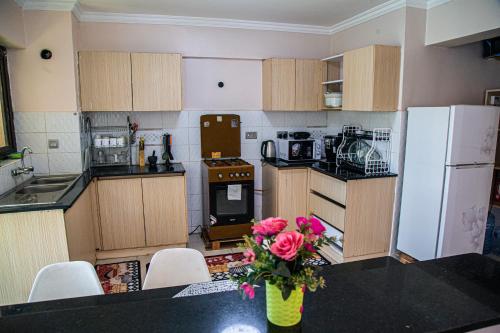 a kitchen with a vase of flowers on a table at The Fancy Luxurious 3 bedroom apartment in Nakuru