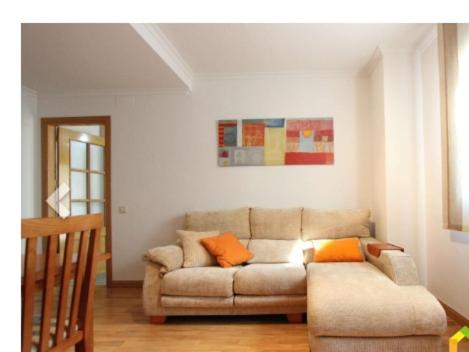 a living room with a couch and orange pillows at Toledo Enamora Dos - PARKING INCLUIDO in Toledo