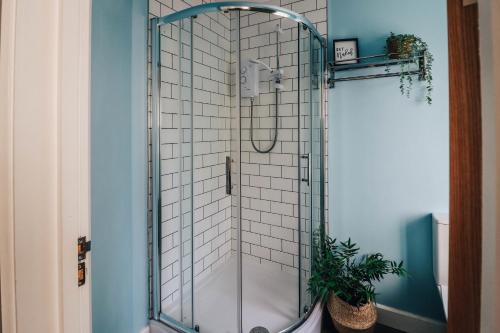 a shower with a glass enclosure in a bathroom at Principality View Apartment Two, by Solace Stays in Cardiff