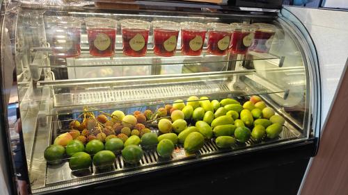a display case filled with lots of apples and other fruits at Slow Tune Space Backpacker Hostel in Jinghong