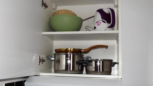 a pot and pans in a kitchen shelf at Split City View Juliet in Split