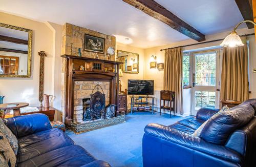 a living room with a couch and a fireplace at Lower Mill 1 Cottage Broadway in Broadway