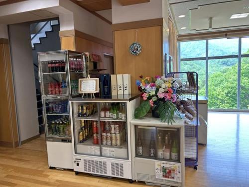 una tienda con una exposición de bebidas y flores en Asakusa Sanso en Uonuma