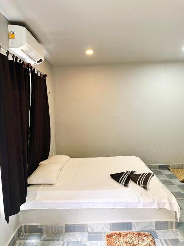 a bed in a room with a black curtain at Angkor Piseth Homestay in Siem Reap