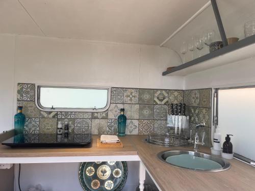 a kitchen with a sink and a counter top at Puckaster Cove Garden Yurt in Niton