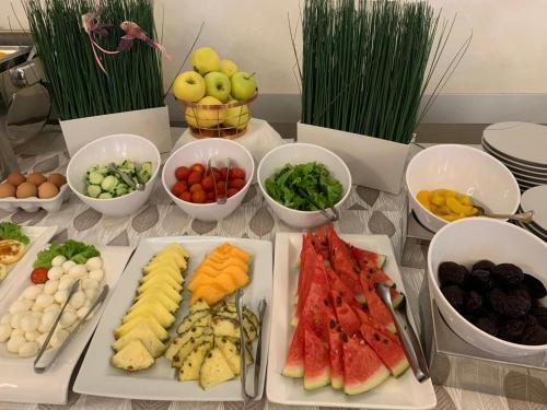 a table topped with different types of fruits and vegetables at Hotel Villa Paola in Rimini
