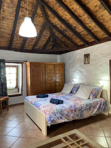a bedroom with a bed and a wooden ceiling at La Puerta del Sol in Adeje