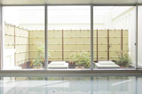 a view of a swimming pool from the window of a house at Hotel Nishi In Fujisan in Fuji
