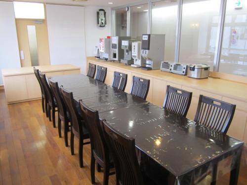a conference room with a black table and chairs at Hotel Nishi In Fujisan in Fuji
