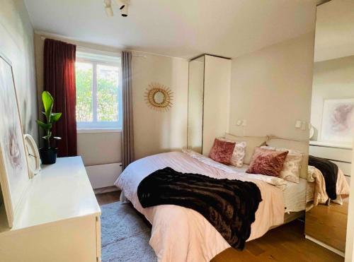 a bedroom with a large bed and a window at Central apartment with an amazing view in Oslo