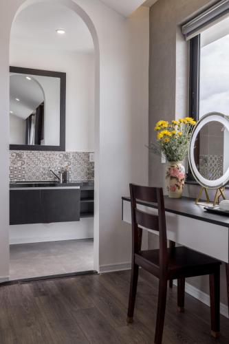 a bathroom with a desk and a mirror at Charm Champion Villa Hoian in Hoi An
