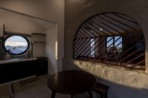 a room with a table and a window at Charm Champion Villa Hoian in Hoi An