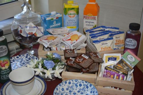 a table with a bunch of food and drinks at Fedro Domus (Vacanze Pompeiane) in Pompei