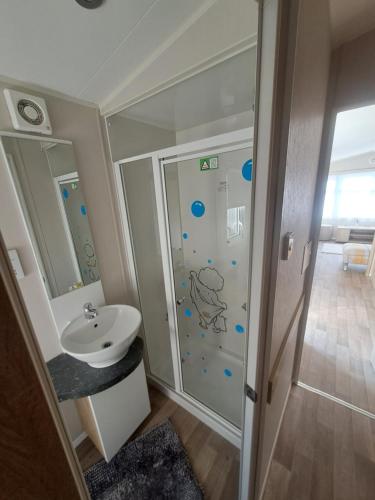 a bathroom with a shower and a sink at 45 Sandringham in Blackpool