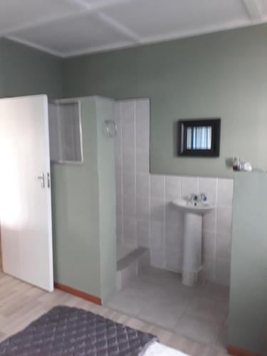 a bathroom with a toilet and a sink in it at Porta Salutis in Port St Johns