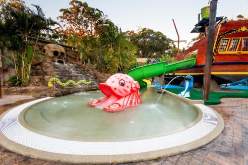 a water slide in a pool at a water park at NRMA South West Rocks Holiday Park in South West Rocks