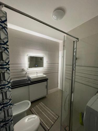 a bathroom with a sink and a toilet and a mirror at Duos Rios in Mostar