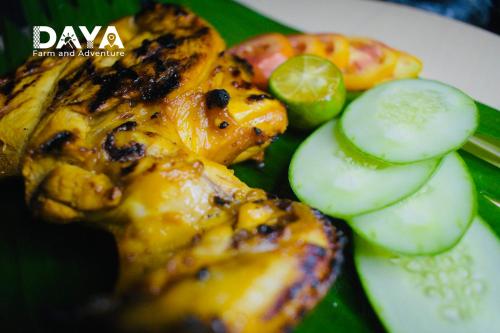 a plate of food with chicken and cucumbers on it at Daya Farm and Adventure in Banay-Banay